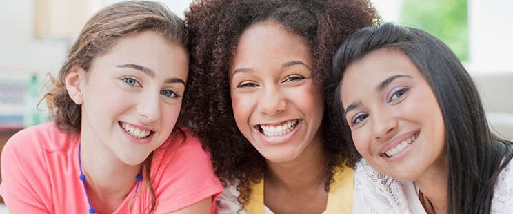 three smiling teen girls